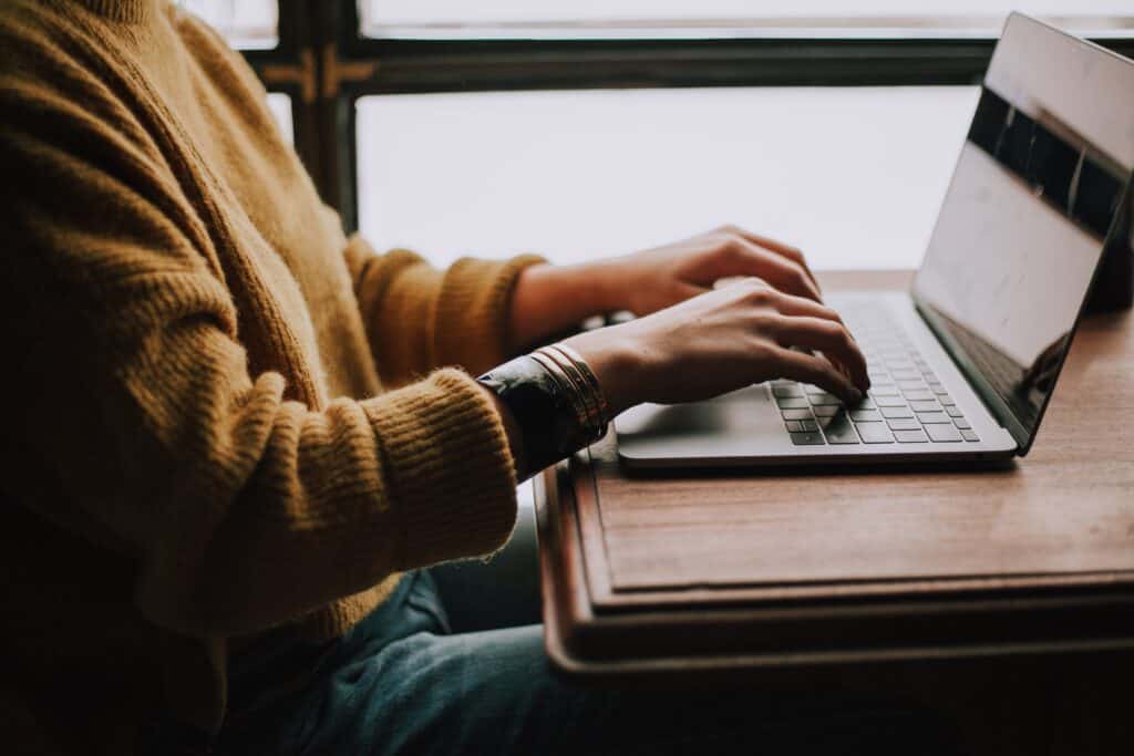 Person typing on notebook