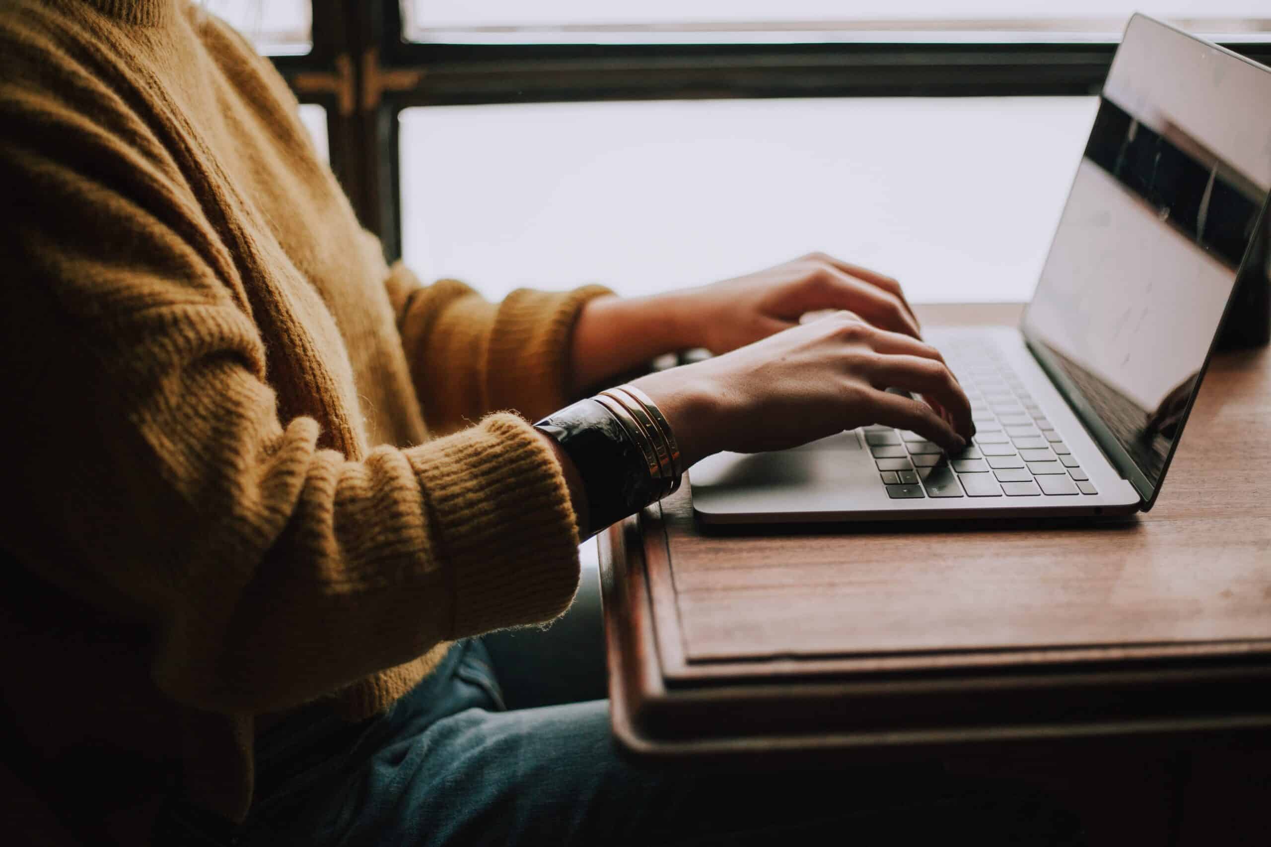 Person typing on notebook
